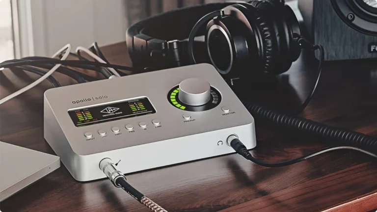 Close up of an Apollo Solo Audio Interface on a wood desk.