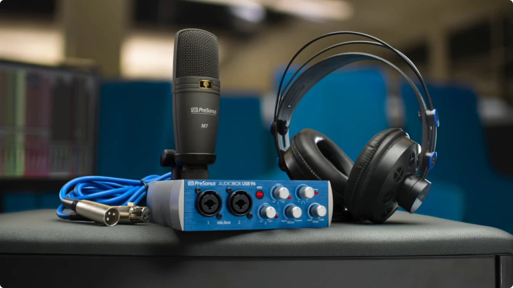 Presonus Audiobox USB 96 Review - Pressonus audio interface sitting on a desk with a presonus microphone and headphones