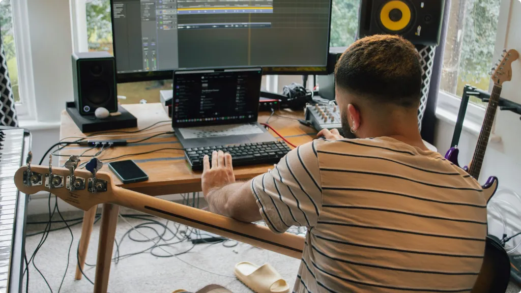 Best Audio Interface for Bass Guitar 2025-Bassist mixing audio in a home studio