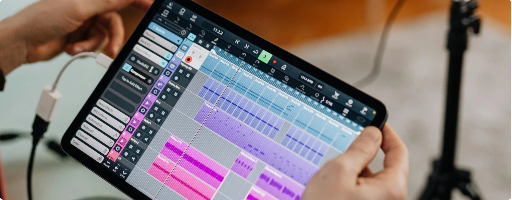 Best Audio Interface for iPad - Top 5 Picks 2025. Person holding an iPad manipulating a DAW