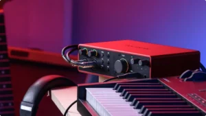 Focusrite Scarlett 2i2 4Th Gen on a desk in a studio environment. Best Audio Interface Under 200